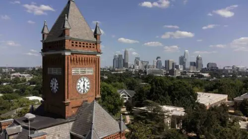 An image of the Biddle Memorial Hall and the Charlotte skyline.