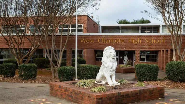 An image of lion mascot and front doors at West Charlotte High School.