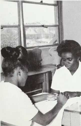 A photo of the manicuring class at West Charlotte High School, one student is practicing what she’s learned.