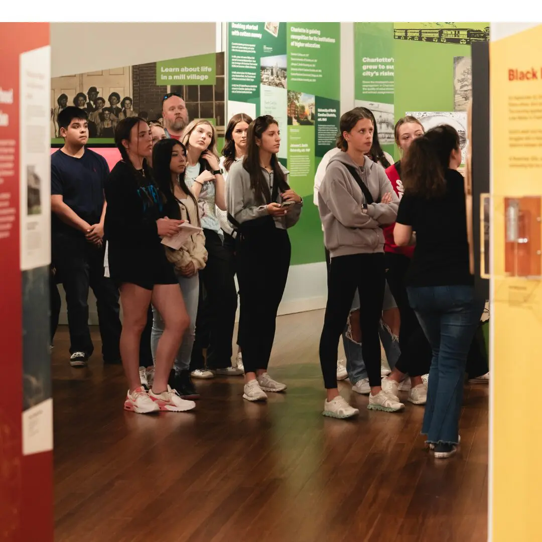 Students during a guided tour of Charlotte: Moving Forward, Looking Back.